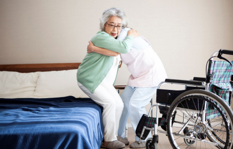 Elderly woman getting out of bed