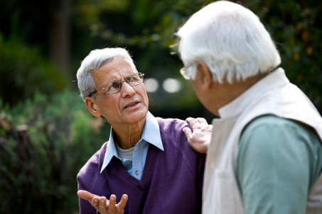 Two elderly men talking