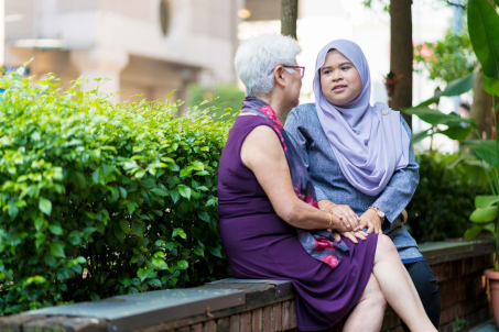Two woman sitting outside having a conversation